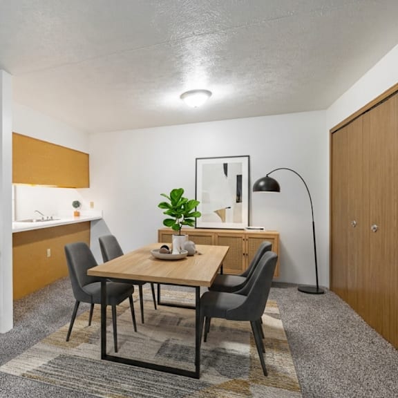 a dining area with a table and chairs.