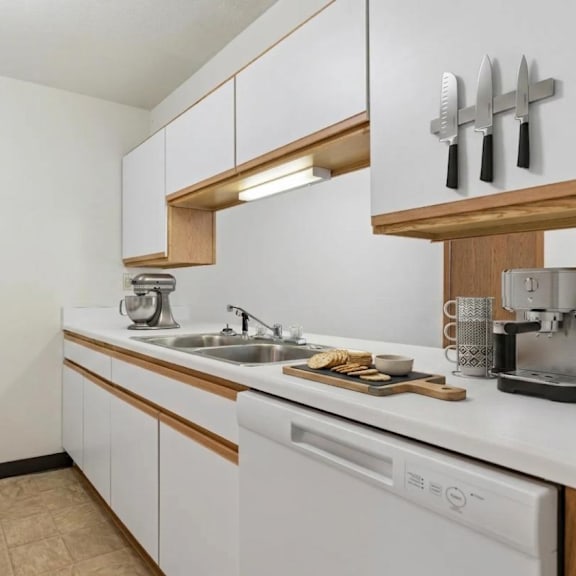 a kitchen with white appliances and wooden accents.