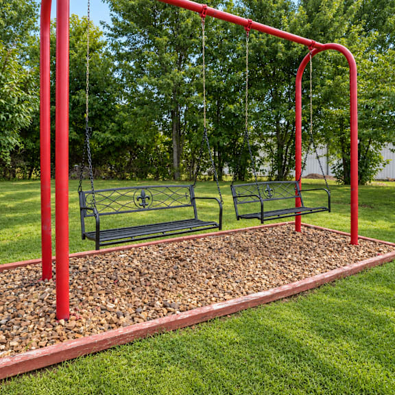 a red swing set with a red pole and a red frame.