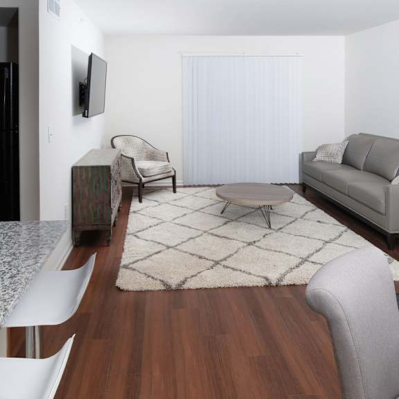living room with plank flooring at gray estates apartments, mrd conventional, st clair mi 48079