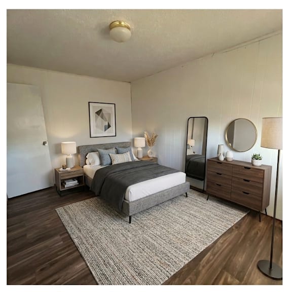 a bedroom with a bed, nightstands, and a dresser.