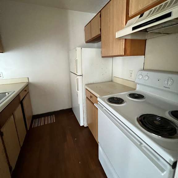 a view of the ceiling of a kitchen with a stove and a refrigerator