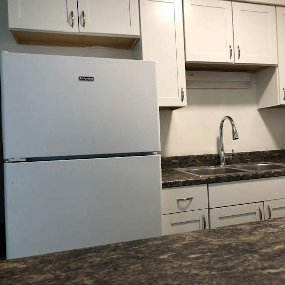 a kitchen with a sink and a refrigerator