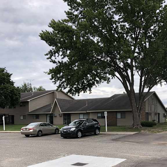 a building with two cars parked in front of it
