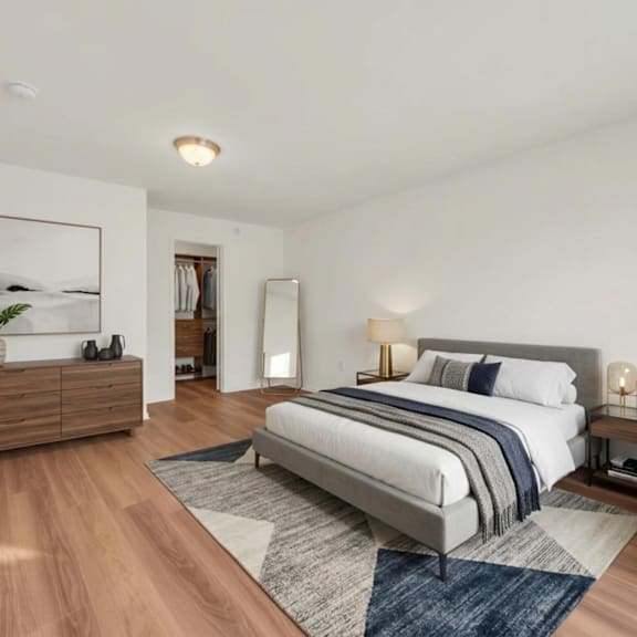 a bedroom with a large bed and a chair.
