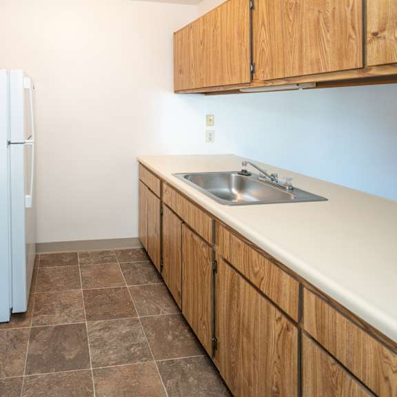 a kitchen with a stove sink and refrigerator