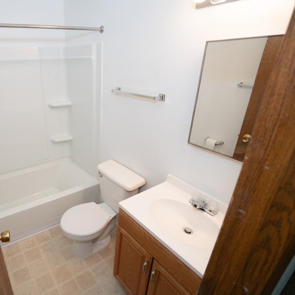 a small bathroom with a sink toilet and shower
