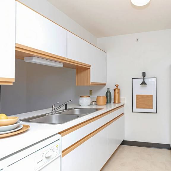 a kitchen with white cabinets and a white fridge.