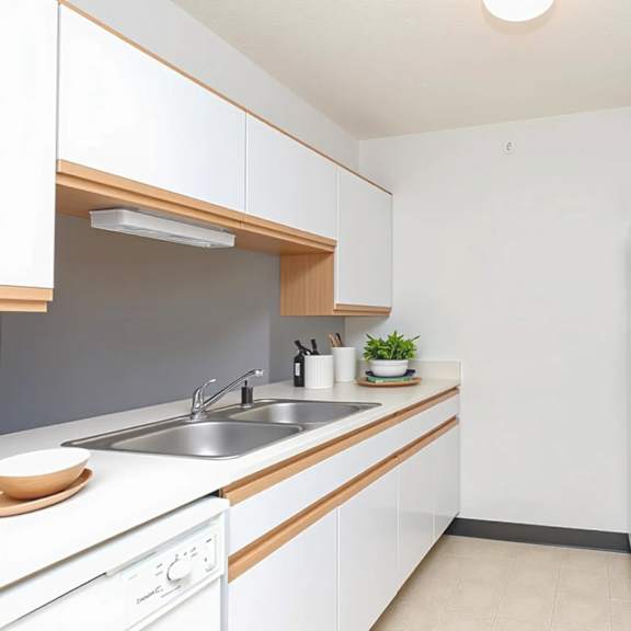 a small, clean kitchen with white cabinets and appliances.