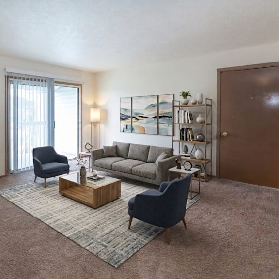 a living room with a blue chair and a grey sofa.