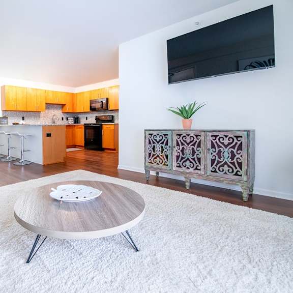 living room with tv at oliver apartments, temperance, 48182