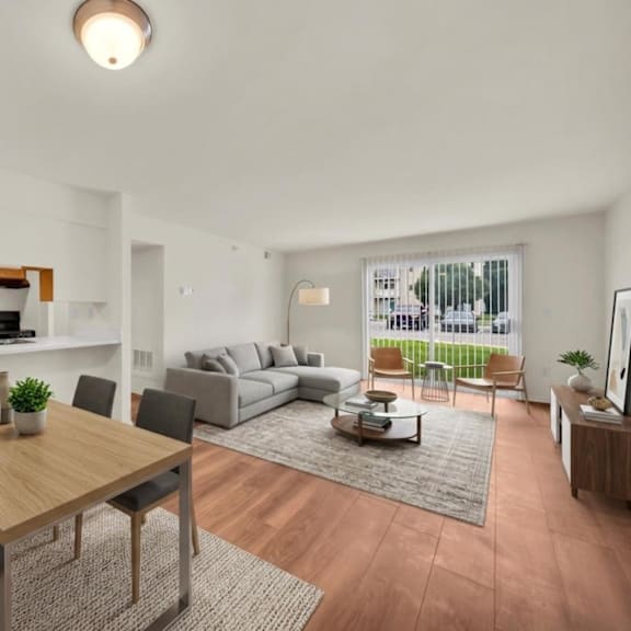 a modern living room with a dining table and chairs.