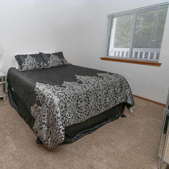 spacious bedroom with comfortable bed at raleigh house apartments, mrd apartments, east lansing, 48823