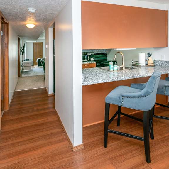 fitted kitchen with island dining at raleigh house apartments, mrd apartments, east lansing, michigan