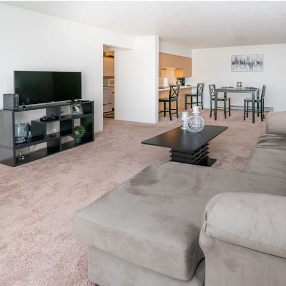 a living room with a large couch and a tv