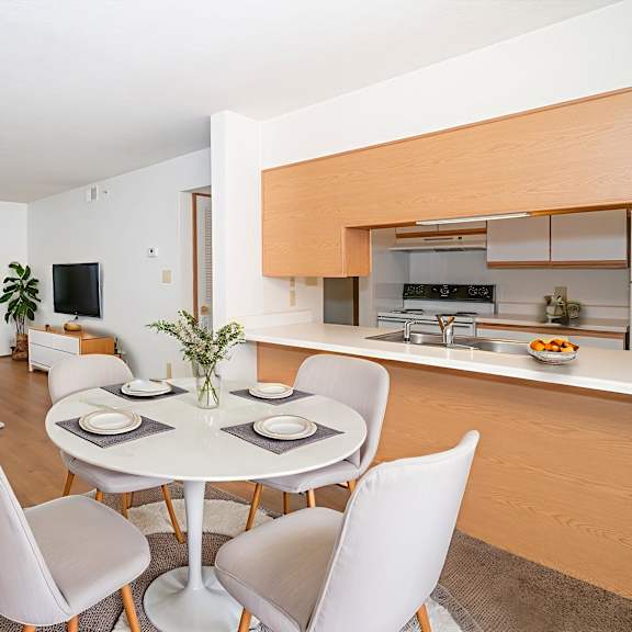 a modern dining room with a white table and chairs.