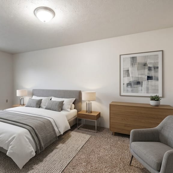 a bedroom with a large bed and a chair.