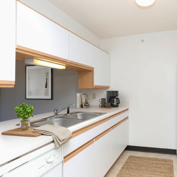 a kitchen with white cabinets and a white fridge.