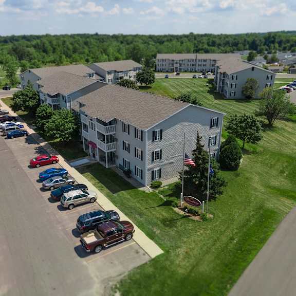 drone view of exterior at woodbury estates apartments, michigan, 49221