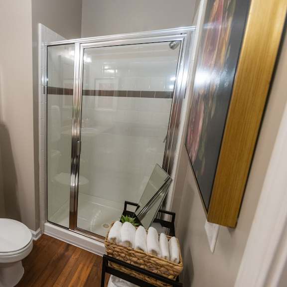 a bathroom with a shower and a toilet and a sink
