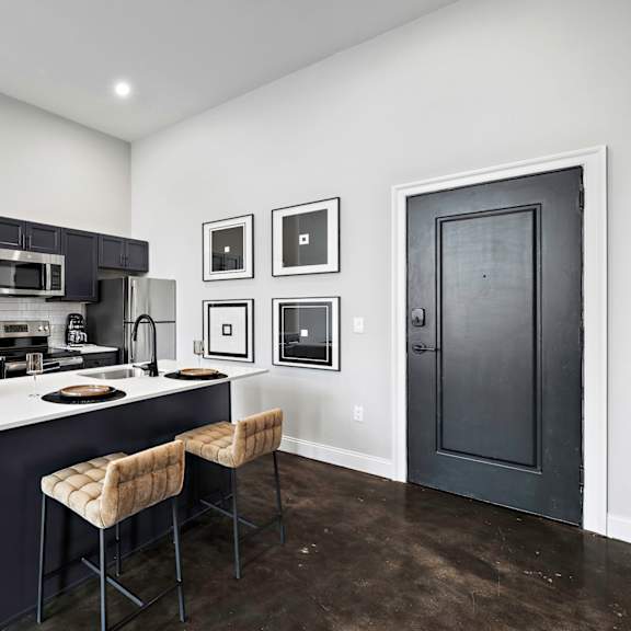 a kitchen with black cabinets and a white counter top