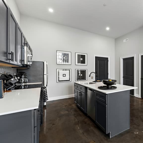 a kitchen with a center island and a counter top in a new home