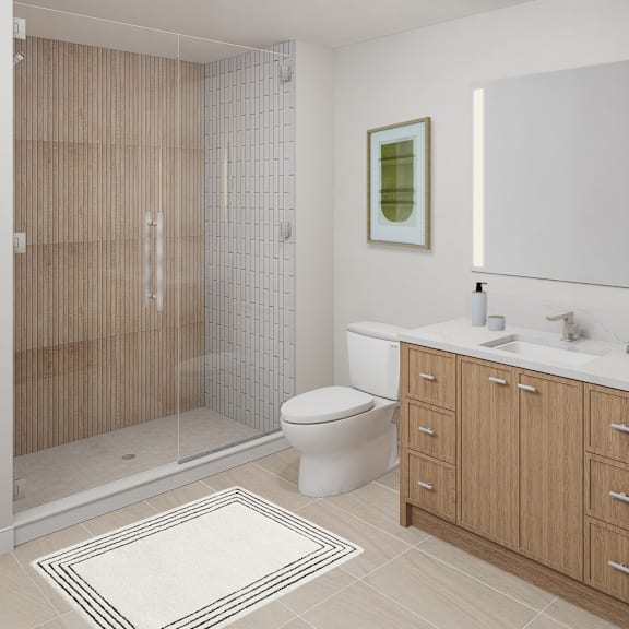 a bathroom with a toilet, sink, and shower.