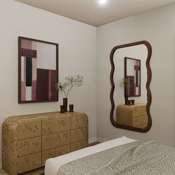 a bedroom with a bed, a chair, a dresser, and a mirror.