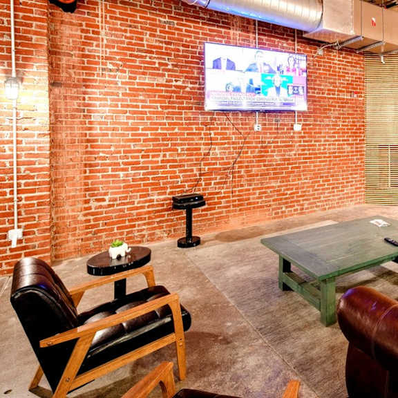 a living room with leather furniture and a tv