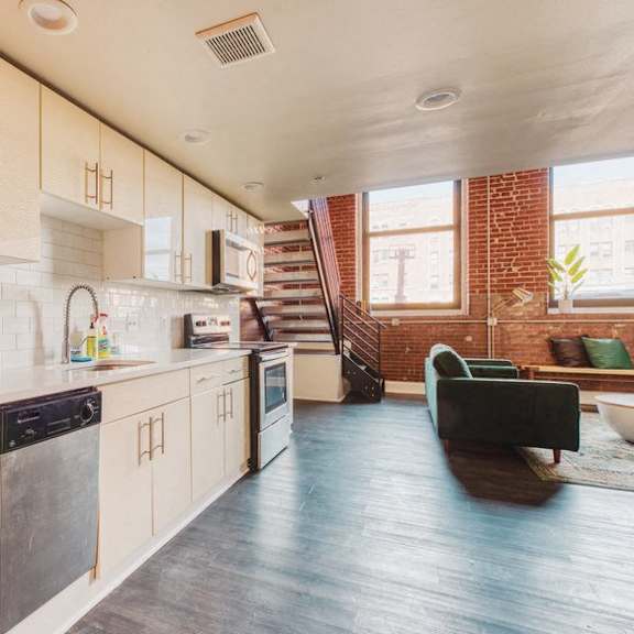 the kitchen is open to the living room and dining room