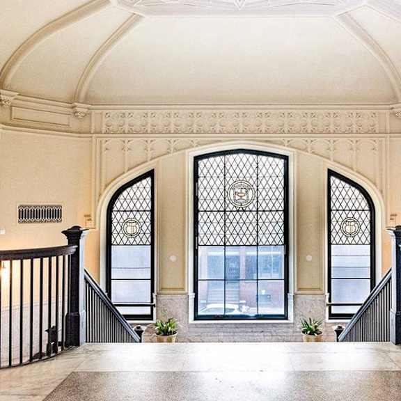 a large window in the middle of a staircase in a building