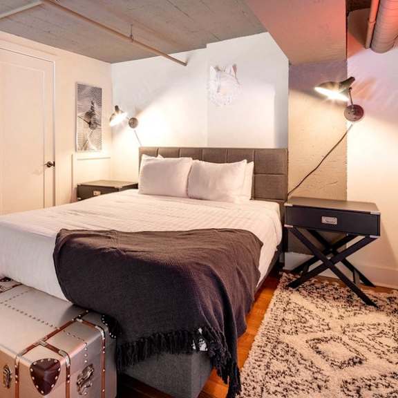 a bedroom with a bed and a suitcase