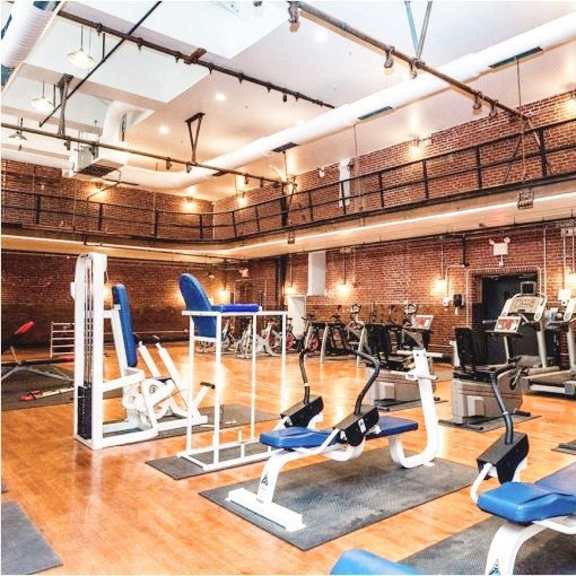 a gym with a bunch of exercise equipment in it