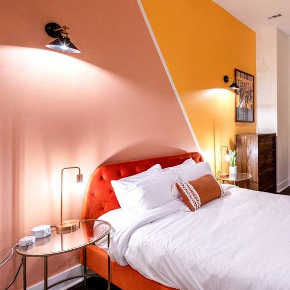 a bedroom with a bed and a chair and a desk