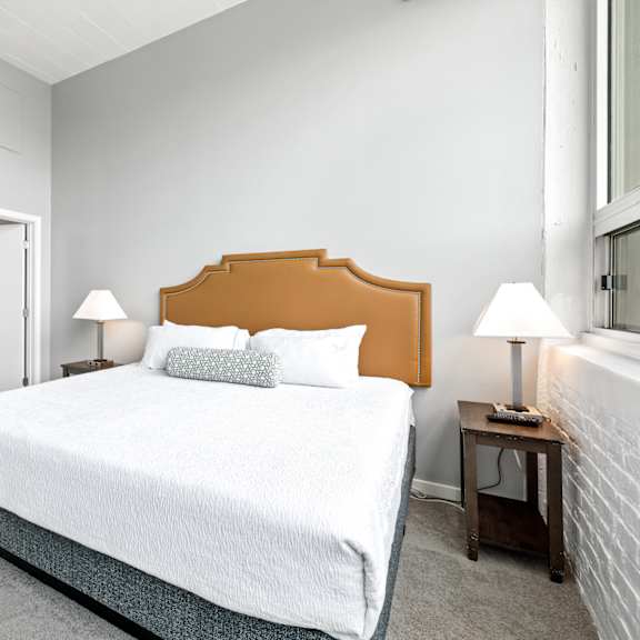 a bedroom with a bed and two nightstands