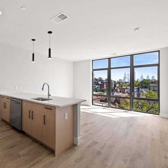 an open kitchen and living room with a view of the city