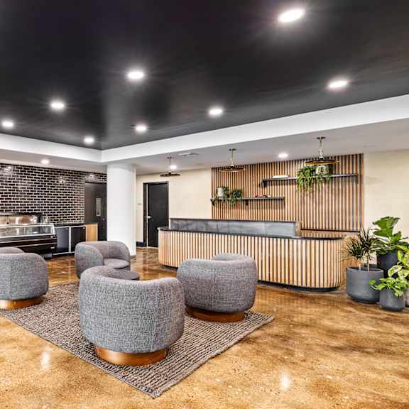 a lobby with a reception desk and chairs