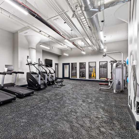 a gym with treadmills and cardio equipment in a building