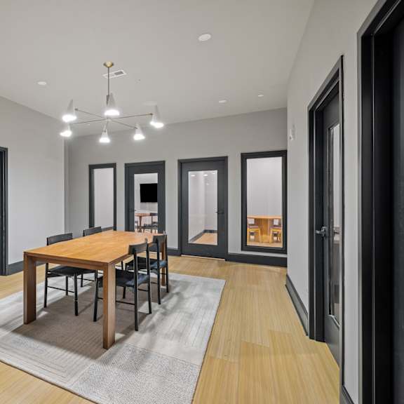 a dining room with a wooden table and chairs