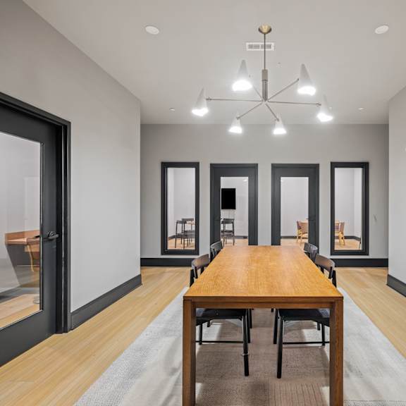 a dining room with a wooden table and chairs and a chandelier