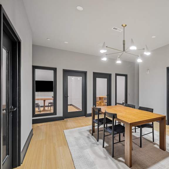 a dining room with a wooden table and chairs
