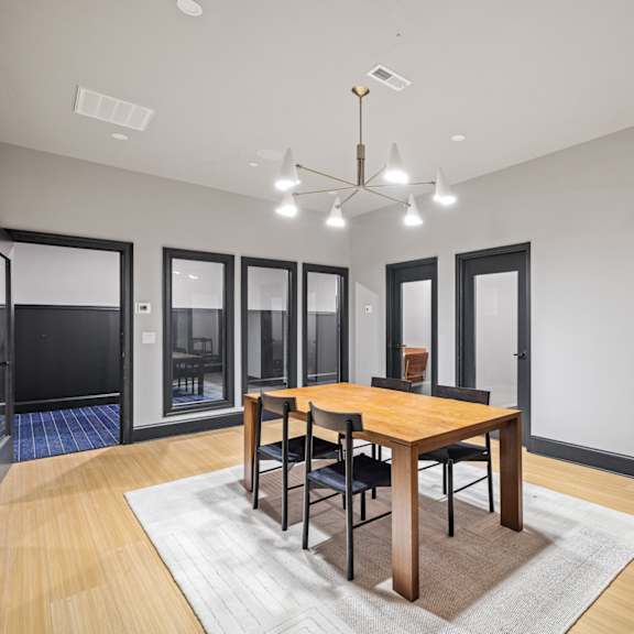 a dining room with a wooden table and chairs