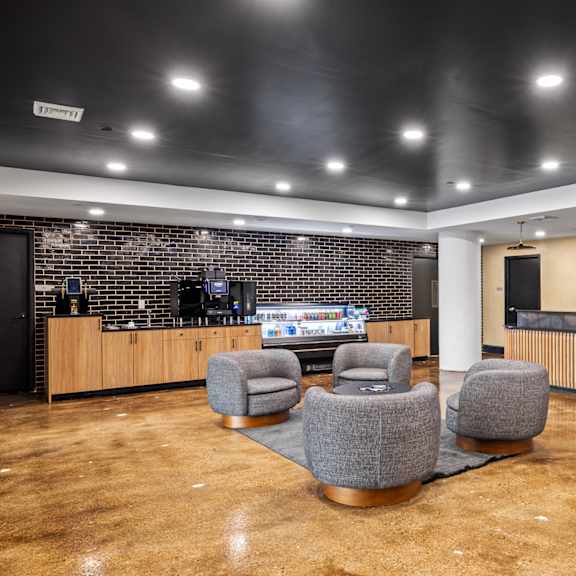 a lobby with chairs and a reception desk