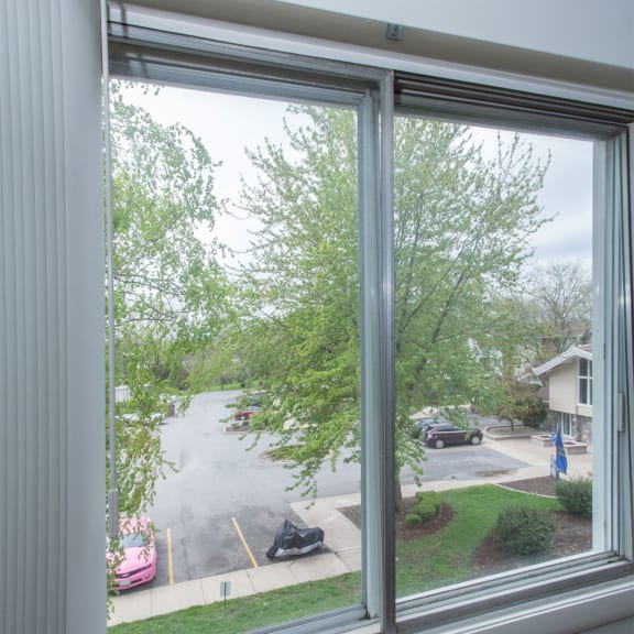 a window with smoke coming out of it and a street outside of it