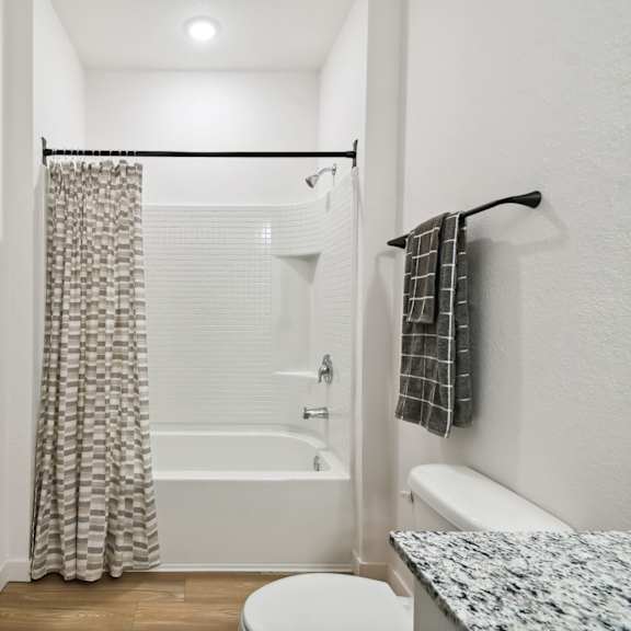 Thumbnail 4 of 4 a bathroom with a shower and a toilet and a shower curtain at Gibson Oaks, Lakeland, 33809