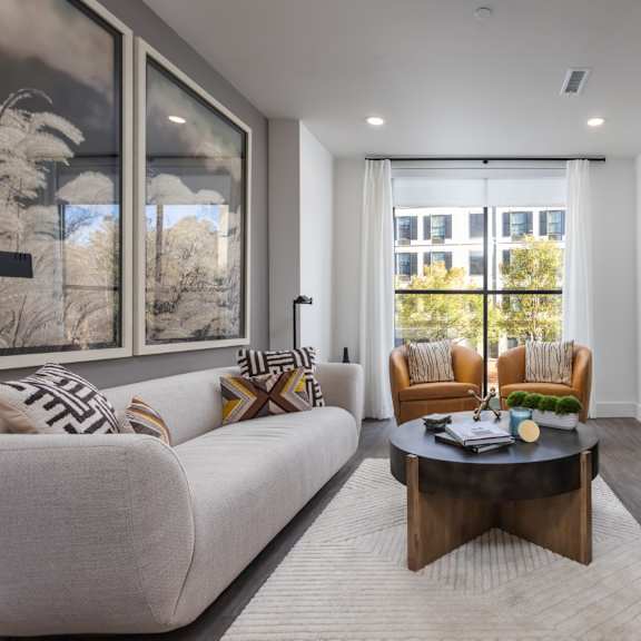 Thumbnail 4 of 6 Modern living room with oversized windows, plank flooring, and premium lighting at 2020 Providence in Huntsville, AL