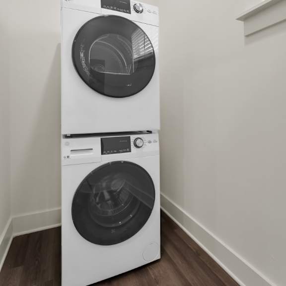 Thumbnail 9 of 9 A white front load washing machine in a room at Turnberry Park Luxury Rental Homes