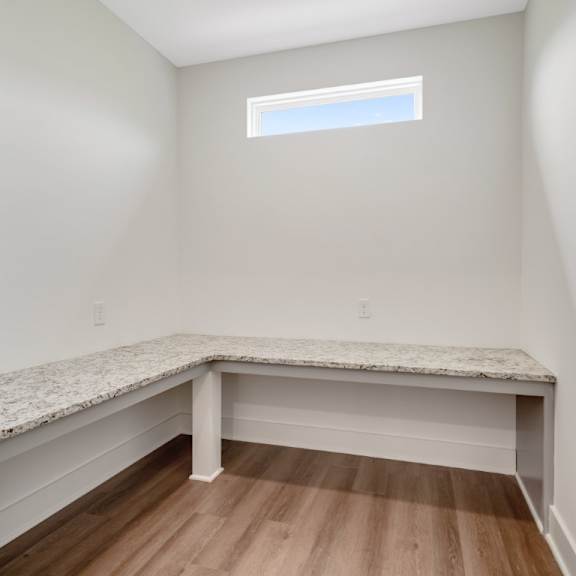 Thumbnail 10 of 13 A mudroom with a bench and a window at Turnberry Park Luxury Rental Homes