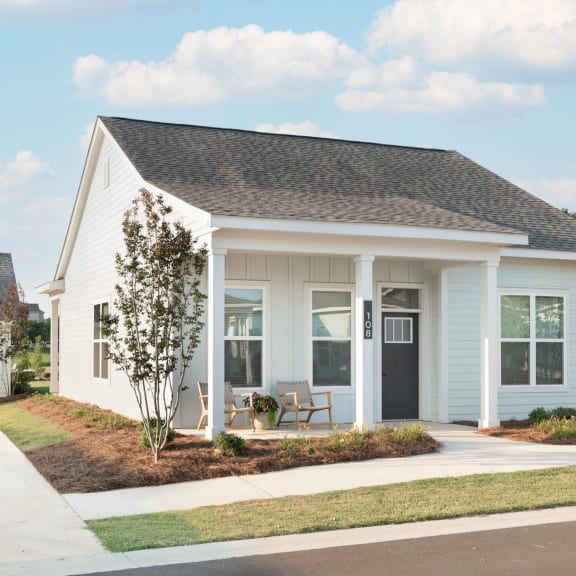 Thumbnail 3 of 3 Cottage-style home with covered porch, 2-car garage, and yard.