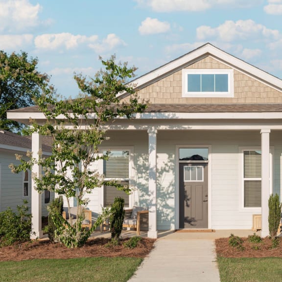 Thumbnail 3 of 3 Cottage-style home with 2-car garage, covered porch, and yard. This floor plan also offers a versatile flex space.